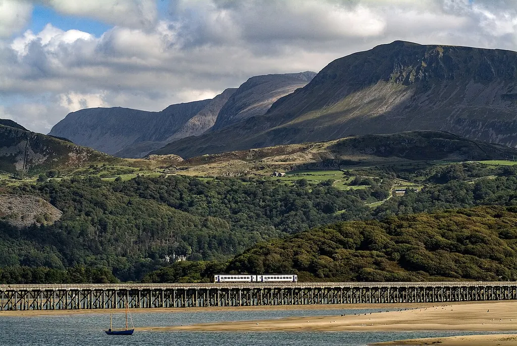 Barmouth Bridge crossing the Mawddach estuary beneath the mountains
