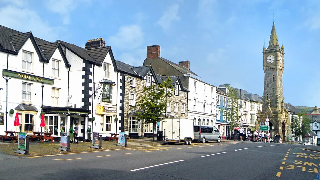 The clock tower and shops along the main street in Machynlleth