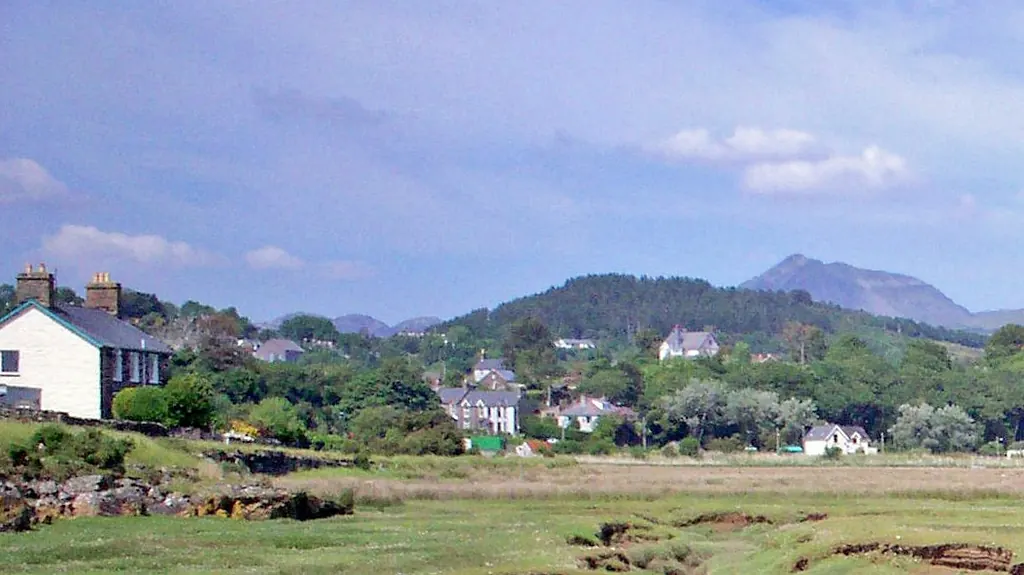 Penrhyndeudraeth seen across the estuary, with hills behind the town