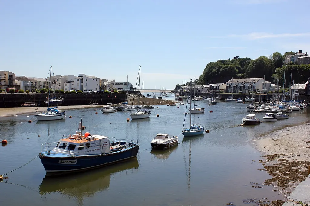 Boats in Porthmadog harbour, with waterfront buildings beyond